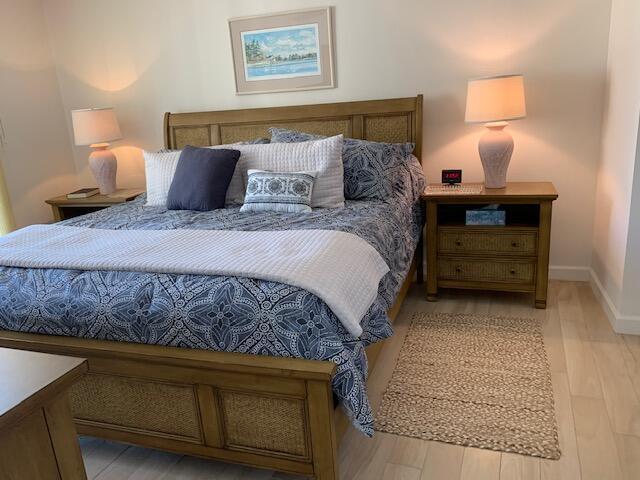 300 Ocean Trail Way, Unit 602 Jupiter, FL 33477 - Photo 5 of 17 a bedroom with a bed and a lamp on dresser