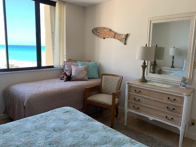 300 Ocean Trail Way, Unit 602 Jupiter, FL 33477 - Photo 8 of 17 a bedroom with a bed and a dresser