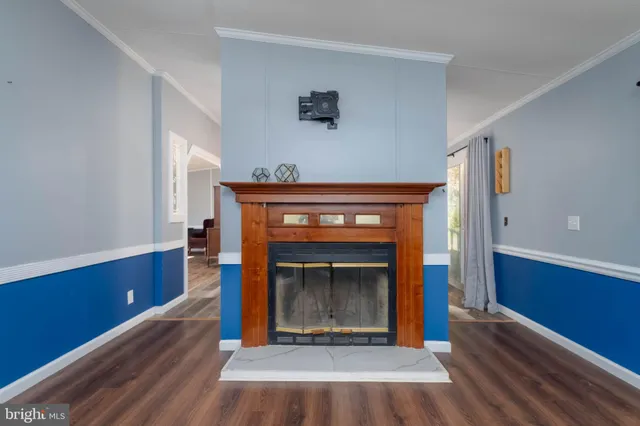 a room with fireplace and a wooden floor