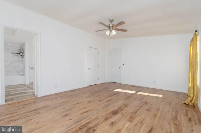 a view of a big room with wooden floor and closet area