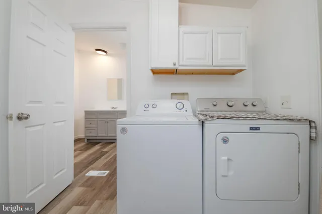 a bathroom with a granite countertop toilet a sink and a mirror