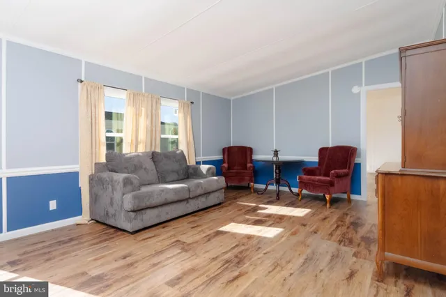 a living room with furniture a couch and a window