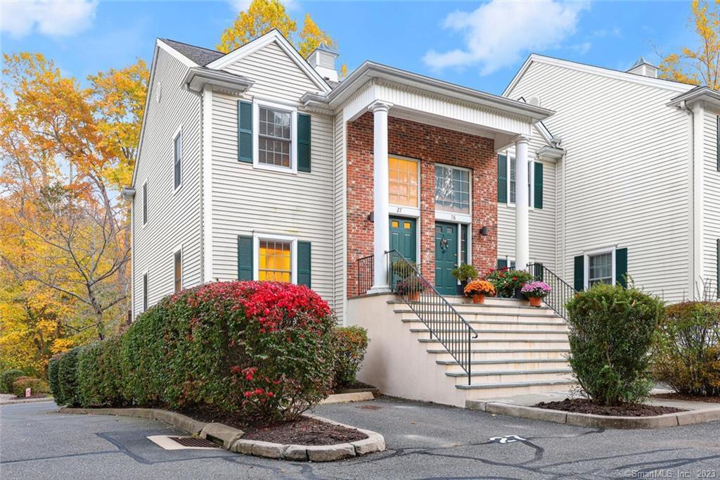 570 Danbury Road, Unit 27 Ridgefield, CT 06877 - Photo 1 of 1 a front view of a house with a yard