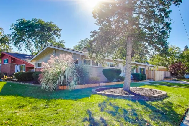 a view of a house with swimming pool and yard