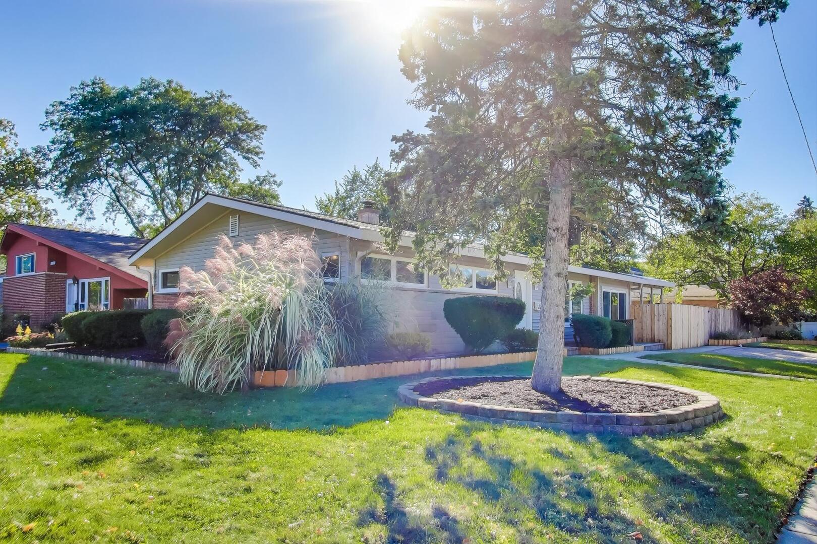 a view of a house with swimming pool and yard