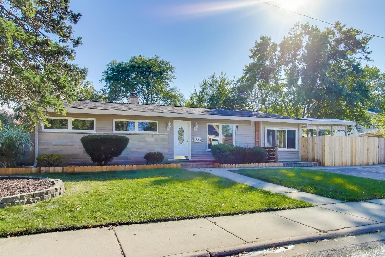 828 Dell Road Northbrook, IL 60062 - Photo 2 of 37 a view of a house with a yard and a garden