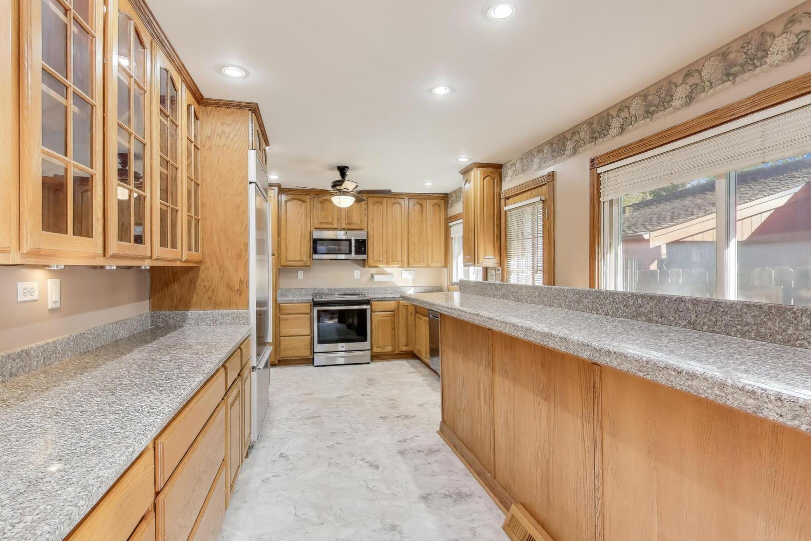 828 Dell Road Northbrook, IL 60062 - Photo 9 of 37 a large kitchen with stainless steel appliances granite countertop a large counter top a stove and a sink