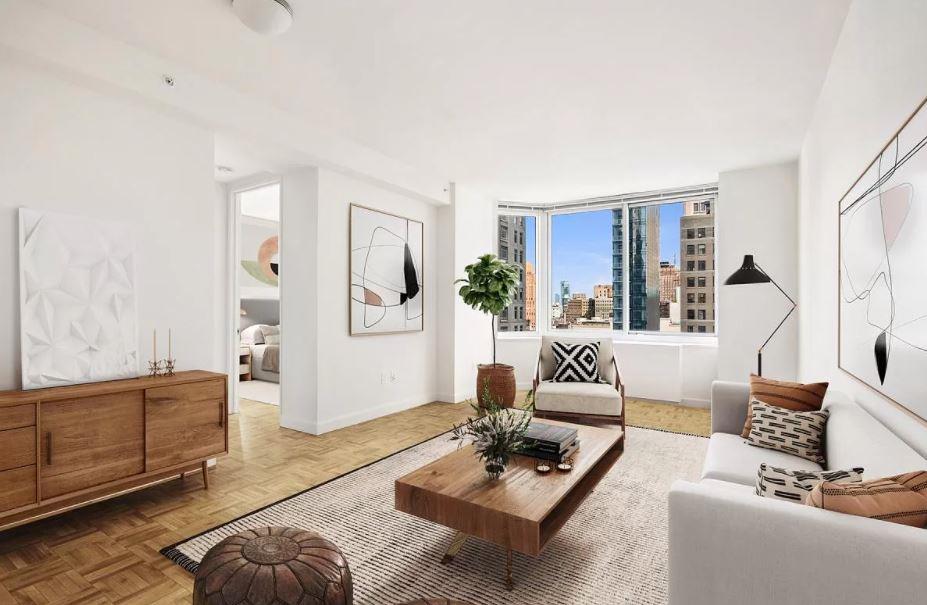 10 Barclay Street, Unit 10C Manhattan, NY 10007 - Photo 1 of 10 a living room with furniture and a couch