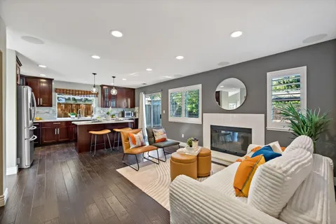 a large kitchen with stainless steel appliances granite countertop a stove and wooden floor