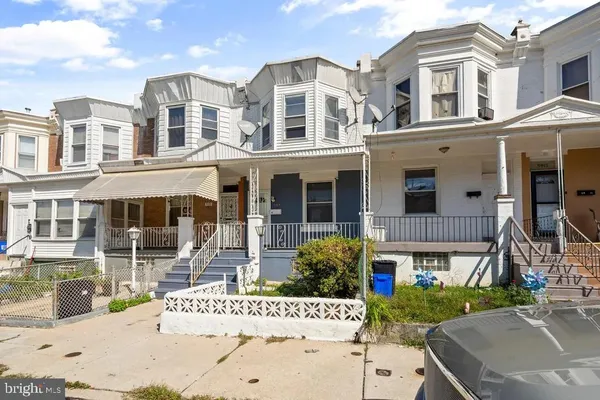 a front view of a building with a garden and pathway