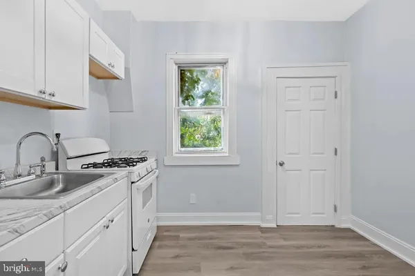 a kitchen with a stove a sink and a microwave