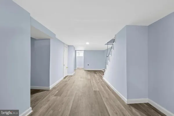 a view of a hallway with wooden floor