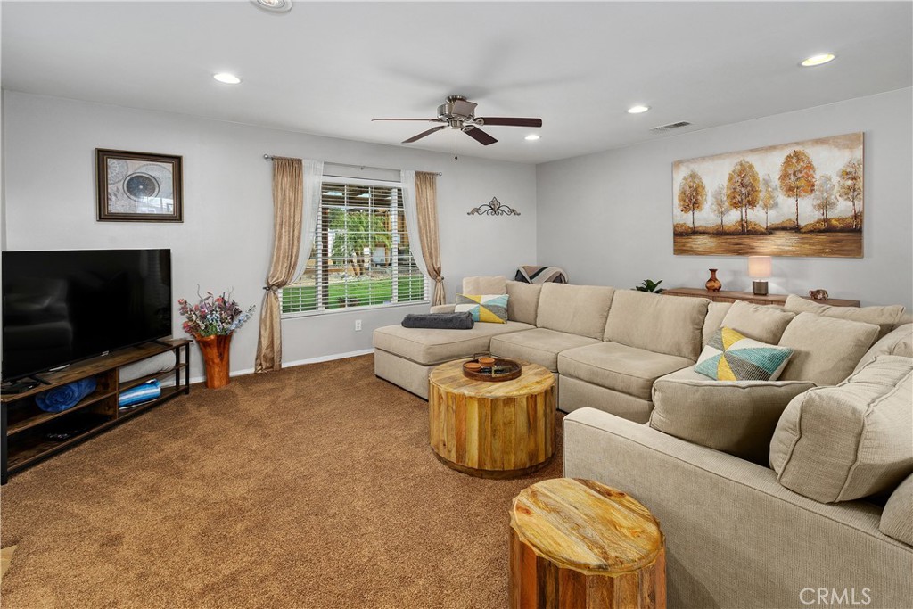 34990 County Line Road Yucaipa, CA 92399 - Photo 11 of 51 a living room with furniture and a flat screen tv