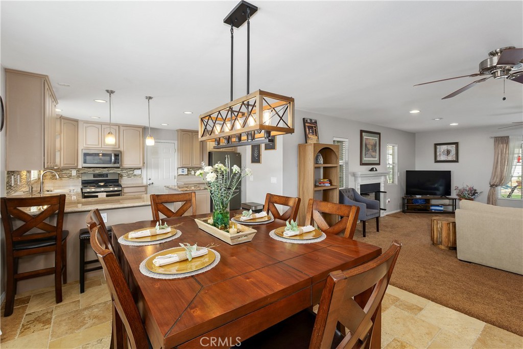 34990 County Line Road Yucaipa, CA 92399 - Photo 14 of 51 a view of a dining room and livingroom with furniture wooden floor a chandelier