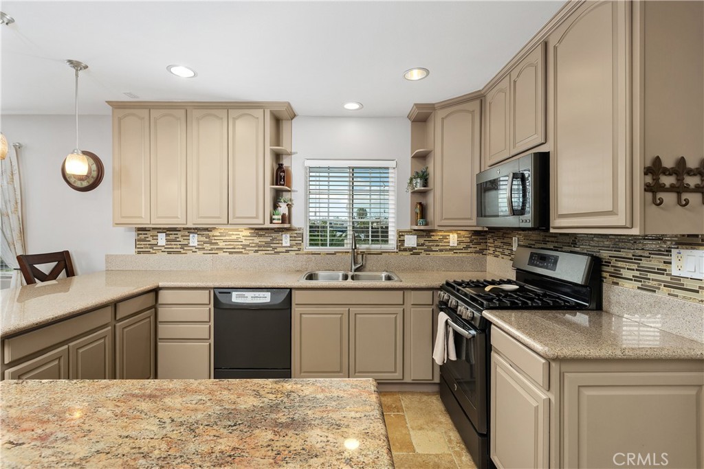 34990 County Line Road Yucaipa, CA 92399 - Photo 18 of 51 a kitchen with stainless steel appliances granite countertop a sink a stove a refrigerator and cabinets