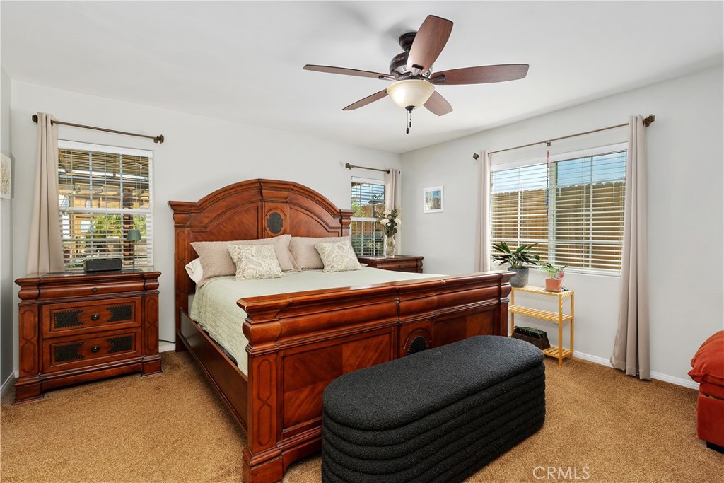 34990 County Line Road Yucaipa, CA 92399 - Photo 23 of 51 a bedroom with a bed and a dresser next to a window