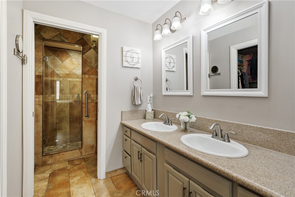 34990 County Line Road Yucaipa, CA 92399 - Photo 26 of 51 a bathroom with a granite countertop sink and a mirror