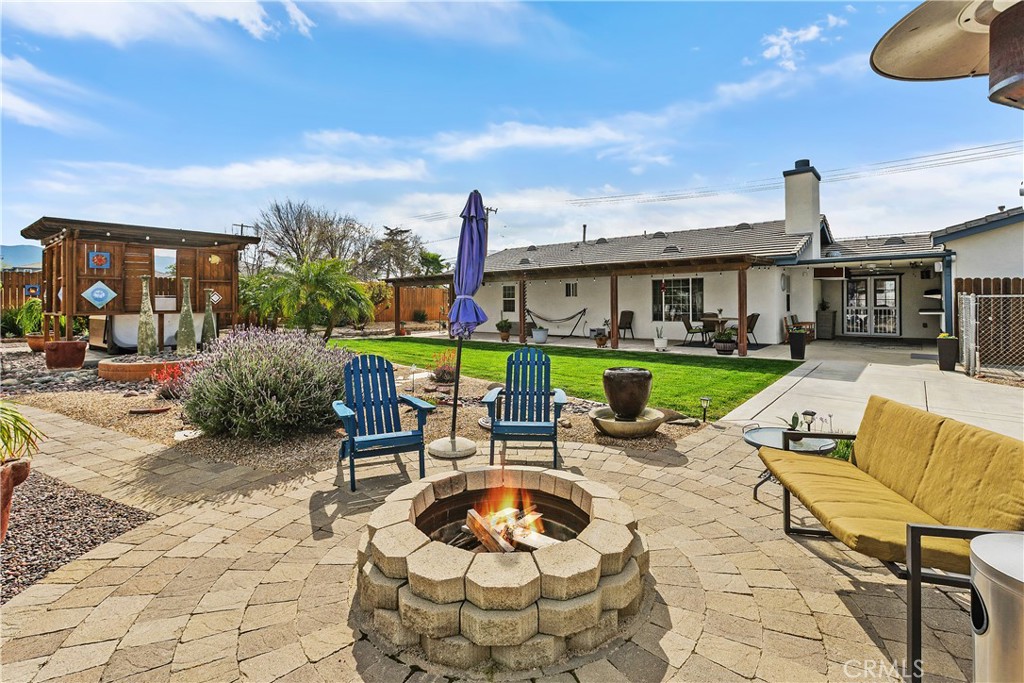 34990 County Line Road Yucaipa, CA 92399 - Photo 37 of 51 a chair and tables in the patio of a house
