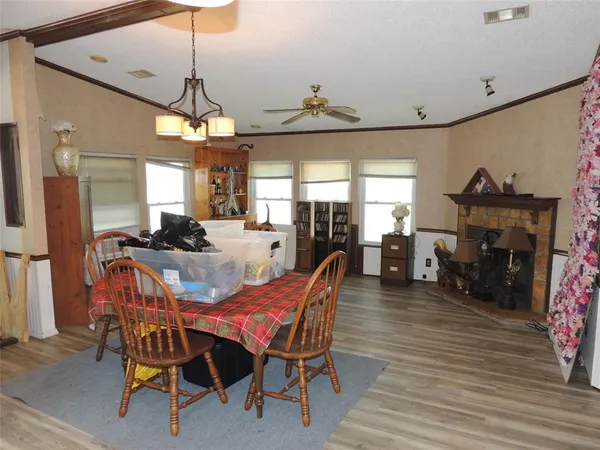 a kitchen with granite countertop a sink cabinets stainless steel appliances and a window