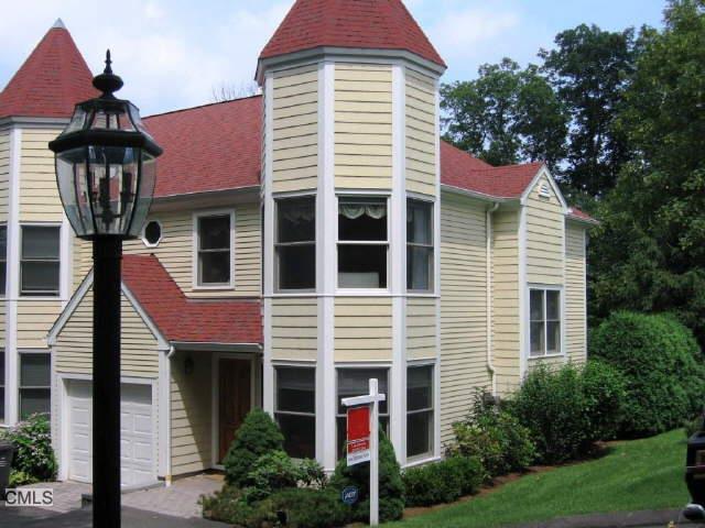 59 Prospect Street, Unit H Ridgefield, CT 06877 - Photo 1 of 1 a front view of a house with yard and trees