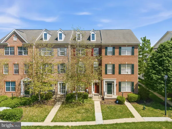 a front view of a residential apartment building with a yard