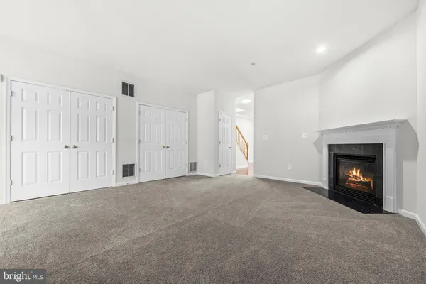 a view of empty room with a fireplace