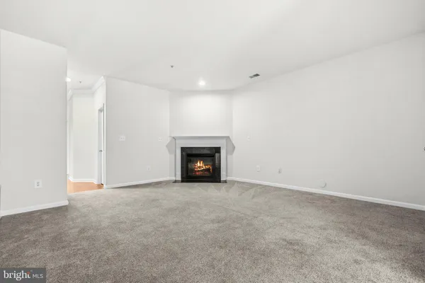 a view of an empty room with a fireplace