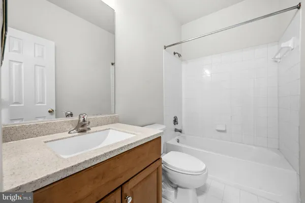 a bathroom with a sink toilet vanity and shower
