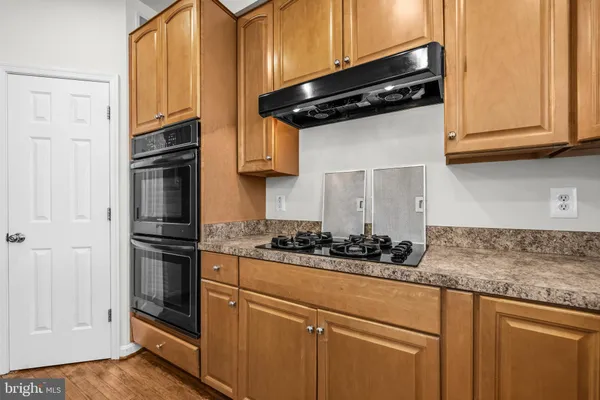 a kitchen with stainless steel appliances granite countertop a sink stove and cabinets