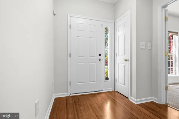 a view of a room with wooden floor and closet