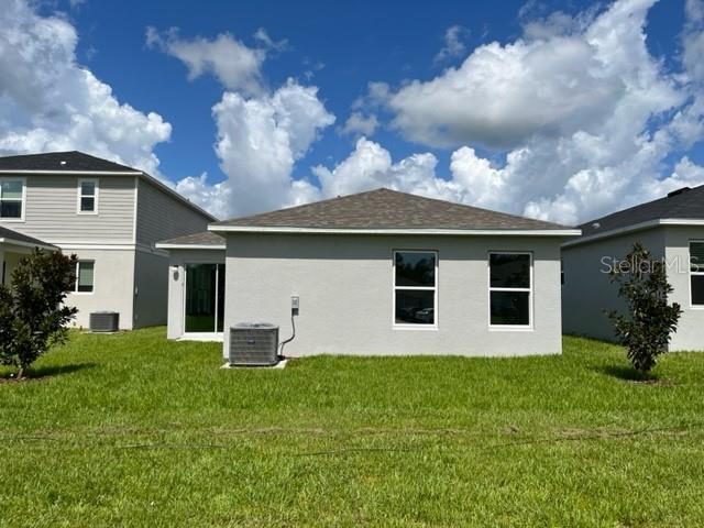 2792 Mdw Strm Way Clermont, FL 34714 - Photo 17 of 21 a front view of a house with a yard and garage