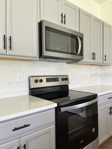 a kitchen with microwave cabinets and stainless steel appliances