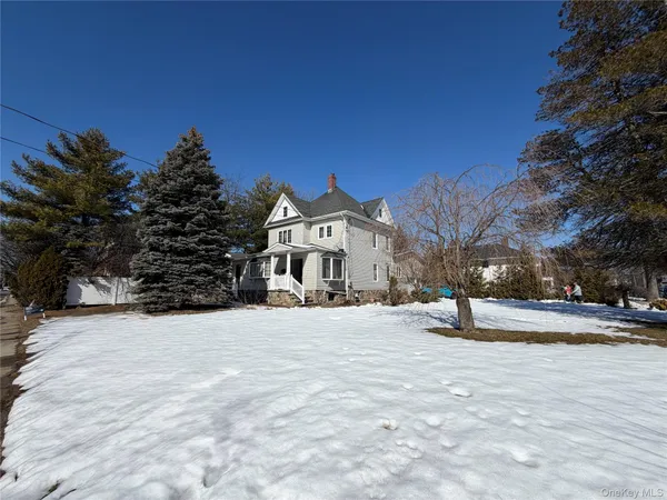 a view of a house with a snow in the yard