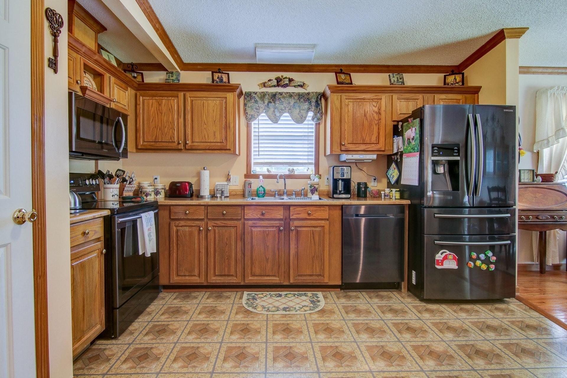 3762 Spradlin Road Goodview, VA 24095 - Photo 14 of 36 a kitchen with stainless steel appliances granite countertop a refrigerator and a stove