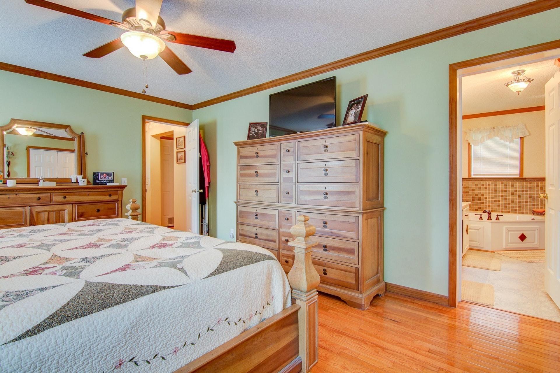 3762 Spradlin Road Goodview, VA 24095 - Photo 18 of 36 a bedroom with a bed and a chandelier