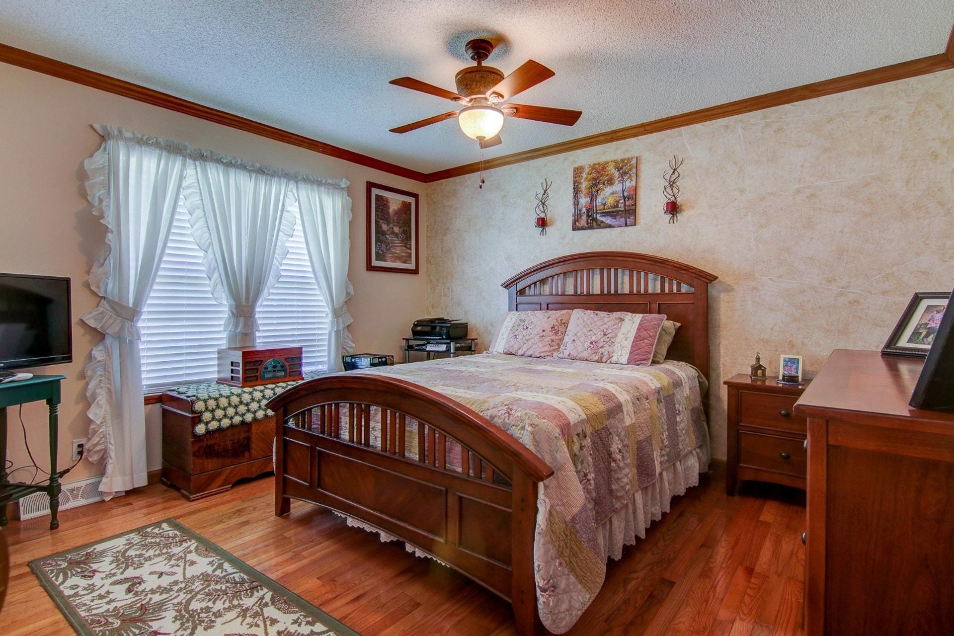 3762 Spradlin Road Goodview, VA 24095 - Photo 24 of 36 a bedroom with a bed and a chandelier