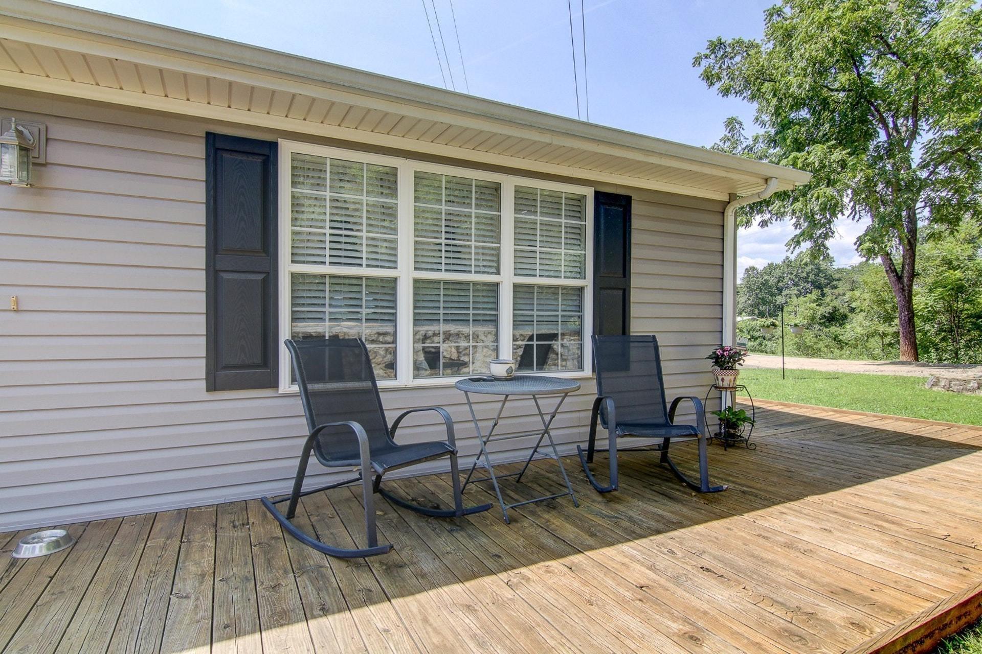 3762 Spradlin Road Goodview, VA 24095 - Photo 26 of 36 a balcony with wooden floor table and chairs