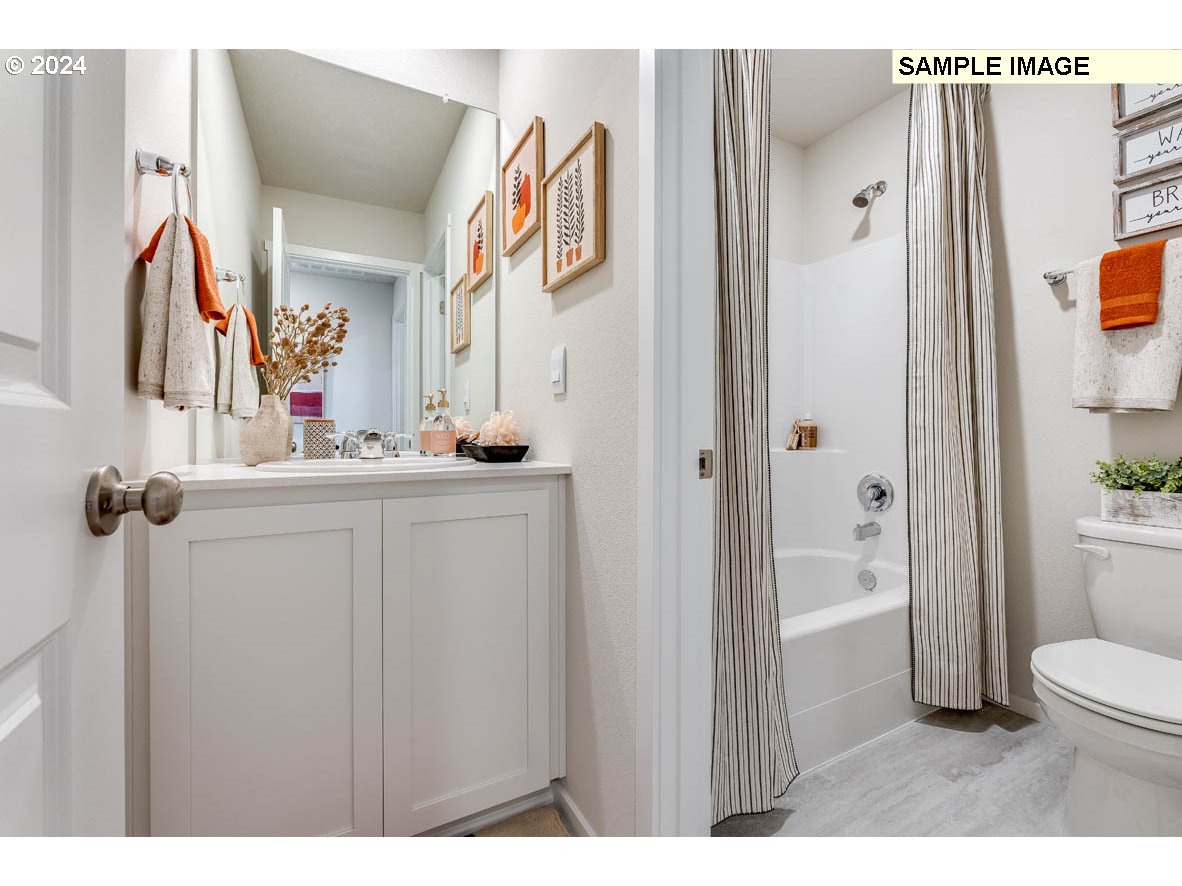 17517 Northwest 10th Place Ridgefield, WA 98642 - Photo 16 of 25 a bathroom with a sink vanity mirror and toilet