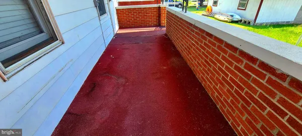 a balcony with stairs and wooden floor