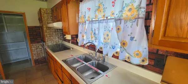a bathroom with a sink and a shower curtain