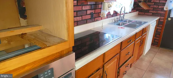 a view of balcony and kitchen with a sink