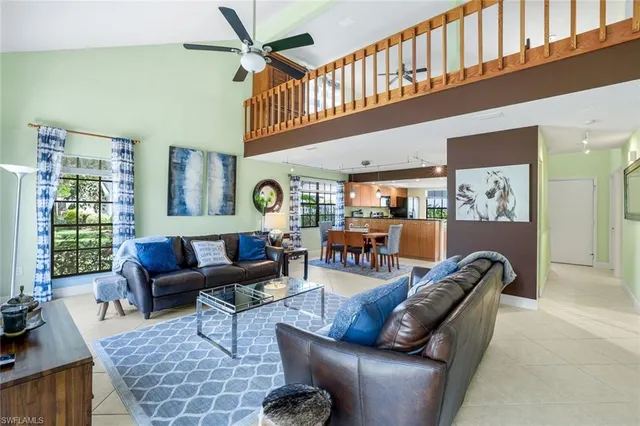a living room with furniture a window and a rug