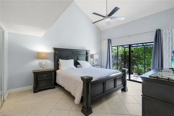 a dining room with furniture and a floor to ceiling window