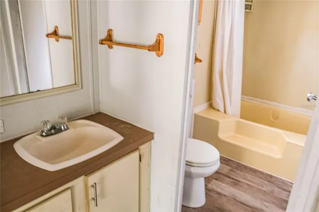 a view of a room with wooden floor