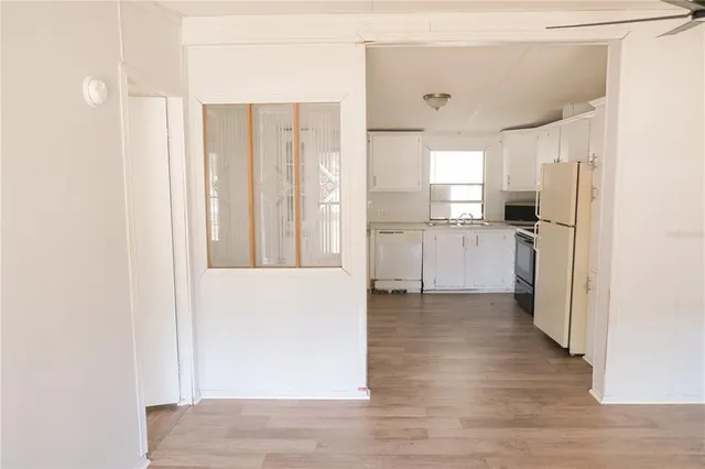 a view of a kitchen with a refrigerator and a sink