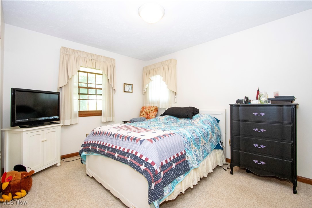 1292 Cinder Road Southeast Carrollton, OH 44615 - Photo 33 of 42 Bedroom featuring light colored carpet and baseboards