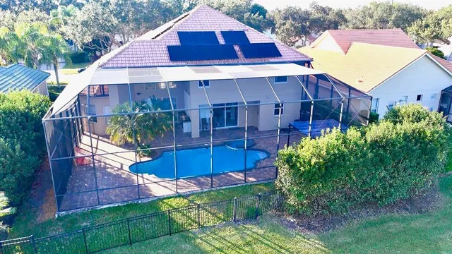 a aerial view of a house with a yard and potted plants