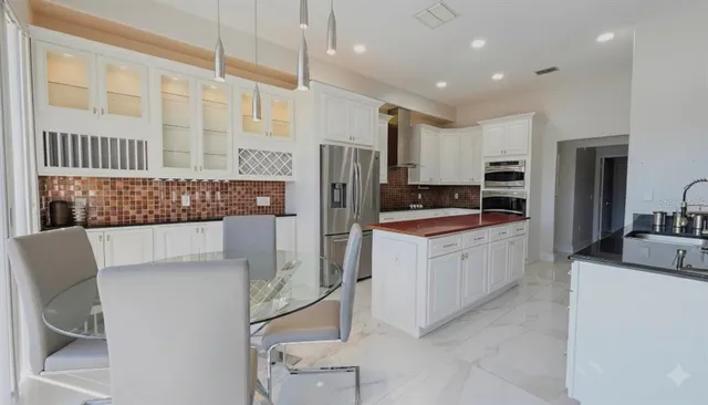 a kitchen with stainless steel appliances a refrigerator sink and stove