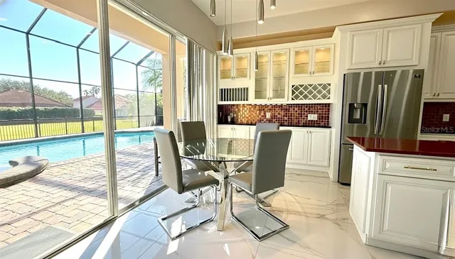 a view of a living room with a floor to ceiling window and a table