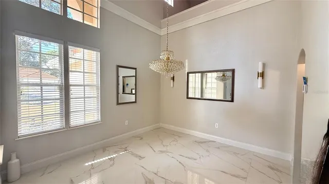 a view of a room with windows and chandelier